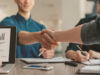 two people shaking hand and closing a deal of being part of the consultant conceptboard