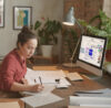 person from critical infrastructure sector sitting at a desk in front of a computer with the conceptboard collaboration tool open. The person is using the tool for the remote job