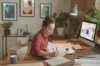 person from critical infrastructure sector sitting at a desk in front of a computer with the conceptboard collaboration tool open. The person is using the tool for the remote job