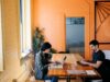Communication in Remote Teams showing 2 people at a desk working
