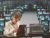Data center Edition or on premises and a person represented in a room full of screens and a laptop next to her on the table with a coding software open