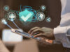 Dedicated server hosting solution representing an abstract image of a person with the laptop and bubbles of security elements popping out of the screen