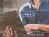 Person with a laptop with an abstract coding going over the entire image describing deployment and implementation
