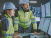 critical infrastructure two people in fron of multiple screens working in critical situations