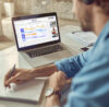 Person sitting in fron of his laptop in a workshop meeting using a digital online whiteboard