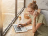 Person with the laptop and a phone at the ear showing remote workshops