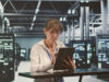 A person with the iPad in the hand in a server room