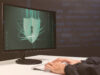 Data security in the defence sector. A person with a computer on its desktop being represented a security shield which depicts the secure collaboration whiteboard tool