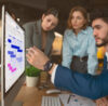 3 people from project management team working on a visual online whiteboard on the Gantt template offered by Conceptboard