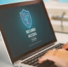 Security hall of fame person with a laptop and a security shield on it