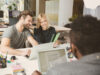 3 people from marketing team wotking together on a projects using online collaboration tool