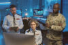 3 people from defence industry work together in front of a laptop. They are responsible for secure collaboration by using a secure whiteboard software