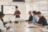 5 People from enterprise sector in a meeting room looking at a big screen with Conceptboard on it