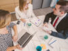 3 people from enterprise sector sitting at a table and working together