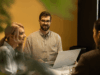 3 employees collaborate in a meeting
