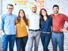 5 happy team members in front of a whiteboard